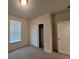 Bedroom with neutral carpet, sliding closet doors and a large window at 1286 Shoreside St, Clermont, FL 34714