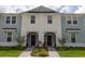 Attractive townhouse with light blue siding, white accents, and a welcoming front entrance at 1286 Shoreside St, Clermont, FL 34714