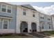 Exterior view of a modern two-story townhouse with beautiful architectural details and landscaping at 1286 Shoreside St, Clermont, FL 34714