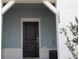 Home exterior with a black front door, white trim, and light blue siding. The house number is visible at 1286 Shoreside St, Clermont, FL 34714