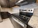 Modern kitchen with stainless steel appliances, granite countertops, and a mosaic backsplash at 1286 Shoreside St, Clermont, FL 34714