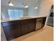 Kitchen island with stainless dishwasher, undermount sink and dark cabinets at 1286 Shoreside St, Clermont, FL 34714