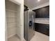 Spacious kitchen features stainless steel appliances, dark cabinets, tile flooring and a walk-in pantry at 1286 Shoreside St, Clermont, FL 34714