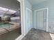 Covered patio area with gray brick pavers and a view of the screened-in outdoor pool at 1286 Shoreside St, Clermont, FL 34714