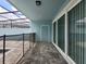 Covered patio with stone pavers, pool fence, and sliding glass doors at 1286 Shoreside St, Clermont, FL 34714