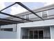 Outdoor screened in patio with views of blue home exterior at 1286 Shoreside St, Clermont, FL 34714