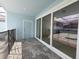 Covered patio area with pool access features sliding glass doors and a safety fence at 1286 Shoreside St, Clermont, FL 34714