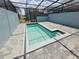 Screened pool with adjacent patio area provides a perfect spot for relaxation at 1286 Shoreside St, Clermont, FL 34714
