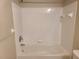 Bathroom featuring a white tiled tub and shower combination at 14001 Fairway Island Dr # 513, Orlando, FL 32837