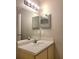 Bathroom vanity with large mirror, vanity lighting and a view into the shower at 14001 Fairway Island Dr # 513, Orlando, FL 32837