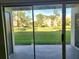 Patio view looking out to a grassy area with mature trees and neighboring condo buildings at 14001 Fairway Island Dr # 513, Orlando, FL 32837