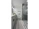 Stylish bathroom with a glass-enclosed shower, double vanity, and modern fixtures at 1412 Pine St, Orlando, FL 32824