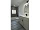 Modern bathroom featuring a shower-tub, gray vanity with a quartz countertop at 1412 Pine St, Orlando, FL 32824