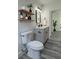 Well-lit bathroom with a gray vanity, open shelving, and modern fixtures at 1412 Pine St, Orlando, FL 32824