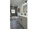 Modern bathroom featuring a shower-tub, floating shelves, and sleek vanity with a quartz countertop at 1412 Pine St, Orlando, FL 32824