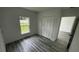 Bright bedroom featuring natural light, closet with bi-fold doors and stylish gray vinyl plank flooring at 1412 Pine St, Orlando, FL 32824