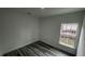 Bright bedroom featuring wood-look flooring, a window and ample space at 1412 Pine St, Orlando, FL 32824