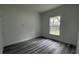 This bedroom features wood-look flooring and a window that provides natural light at 1412 Pine St, Orlando, FL 32824