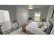 Bright bedroom featuring natural light, closet with bi-fold doors and stylish gray vinyl plank flooring at 1412 Pine St, Orlando, FL 32824