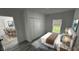 Bright bedroom featuring natural light, closet with bi-fold doors and stylish gray vinyl plank flooring at 1412 Pine St, Orlando, FL 32824