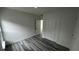 Bright bedroom with wood-look flooring and a spacious closet at 1412 Pine St, Orlando, FL 32824
