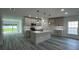 Modern kitchen with island, pendant lights, stainless appliances, and open living area at 1412 Pine St, Orlando, FL 32824