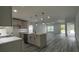 Bright kitchen with island, pendant lights, stainless appliances, and wood-look flooring at 1412 Pine St, Orlando, FL 32824