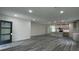 Open-concept living room and kitchen with modern gray cabinets and wood flooring at 1412 Pine St, Orlando, FL 32824