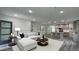 Open-concept living room with stylish decor, flowing into a modern kitchen at 1412 Pine St, Orlando, FL 32824