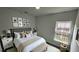 Comfortable main bedroom with neutral tones, stylish furnishings, and a bright window at 1412 Pine St, Orlando, FL 32824