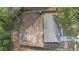 Aerial view of a home with a fire pit and stumps in the backyard, surrounded by mature trees at 14120 Rutgers Ave, Orlando, FL 32826