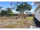 Spacious backyard featuring a cozy fire pit area surrounded by tree stump seating and a wooden fence at 14120 Rutgers Ave, Orlando, FL 32826