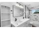 Bathroom featuring double vanity with quartz countertop and walk-in shower with modern fixtures at 14120 Rutgers Ave, Orlando, FL 32826