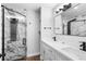 Bathroom featuring double sink vanity, modern fixtures, marble-style tiles and a modern glass enclosed shower at 14120 Rutgers Ave, Orlando, FL 32826