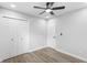 Neutral bedroom features a ceiling fan, new flooring, and a closet for storage at 14120 Rutgers Ave, Orlando, FL 32826