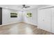 Bright bedroom features wood-look floors, two windows, a ceiling fan, and a closet at 14120 Rutgers Ave, Orlando, FL 32826
