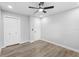 This bedroom features neutral walls, light wood floor, ceiling fan, and a closet for plenty of storage at 14120 Rutgers Ave, Orlando, FL 32826