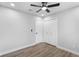 This bedroom offers neutral walls, light wood floors, closet and ceiling fan for a clean and modern look at 14120 Rutgers Ave, Orlando, FL 32826