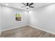 Bright bedroom with a window, ceiling fan, neutral paint, and new flooring at 14120 Rutgers Ave, Orlando, FL 32826