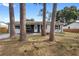 Cozy home featuring a well-manicured front lawn framed by mature trees and natural landscaping at 14120 Rutgers Ave, Orlando, FL 32826
