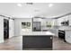 Well-lit kitchen featuring a dark-colored island, stainless appliances, and sliding barn doors at 14120 Rutgers Ave, Orlando, FL 32826