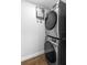 Modern laundry area with stacked washer and dryer, and a tankless water heater at 14120 Rutgers Ave, Orlando, FL 32826