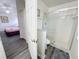 Bathroom with a glass enclosed shower with gray wood-look floors and a neutral color palette at 143 Windsor Pl, Davenport, FL 33896