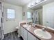 Bright bathroom with double sinks, a shower, and a separate toilet area at 143 Windsor Pl, Davenport, FL 33896