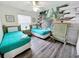Fun bedroom with two twin beds, and large mural of a dinosaur at 143 Windsor Pl, Davenport, FL 33896