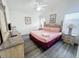 Bright bedroom with a ceiling fan, bed with nightstands, and neutral-colored walls at 143 Windsor Pl, Davenport, FL 33896