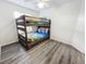 Cozy bedroom with built-in bunk beds, soft gray flooring, and plenty of natural light at 143 Windsor Pl, Davenport, FL 33896