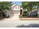 Charming two-story home with red shutters, a well-manicured lawn and a brick driveway at 143 Windsor Pl, Davenport, FL 33896