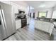 The kitchen has stainless steel appliances and white cabinets at 143 Windsor Pl, Davenport, FL 33896