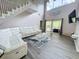 Elegant living room featuring soaring ceilings, a cozy couch, and seamless access to the outdoors at 143 Windsor Pl, Davenport, FL 33896